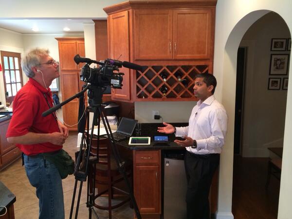 Comcast VP Dennis Mathew discusses the advantages of Xfinity Home with a member of the Atlanta media.
